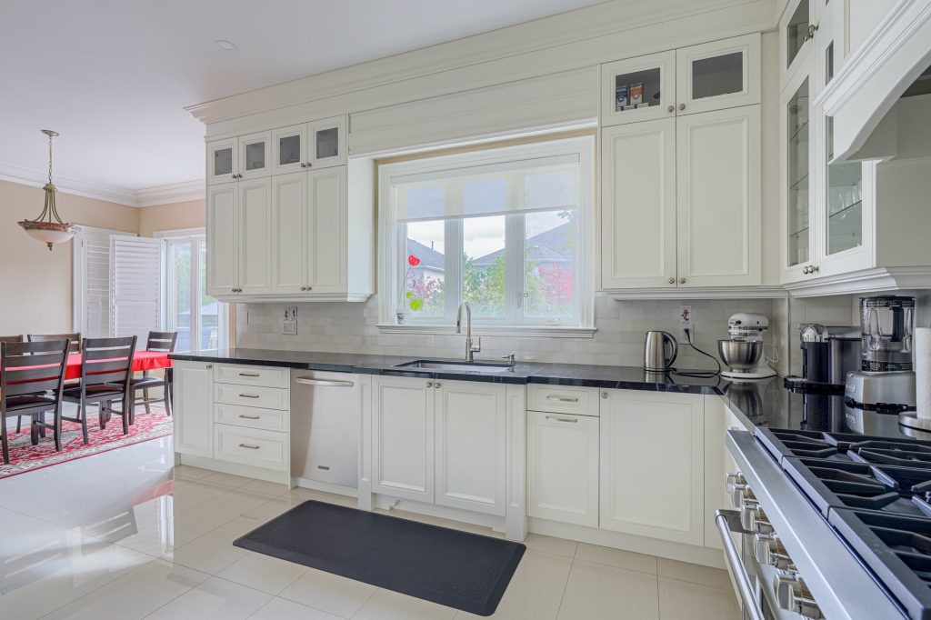 amazing kitchen with crown moudling trim and glass cabinet doors - kitchen design aurora