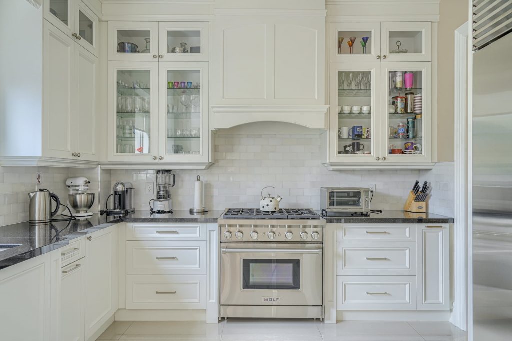 classic kitchen with glass cabinets and build in appliances - kitchen remodeling markham
