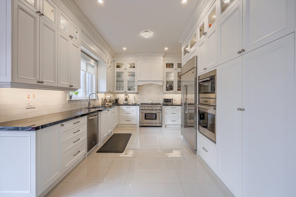 modern kitchen with glass cabinet doors and build in appliances - custom kitchen design