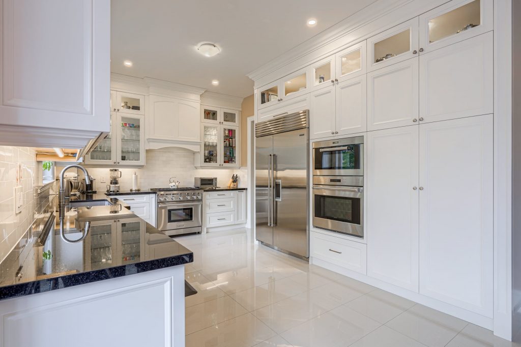 luxury kitchen with marble black counter top - kitchen refacing