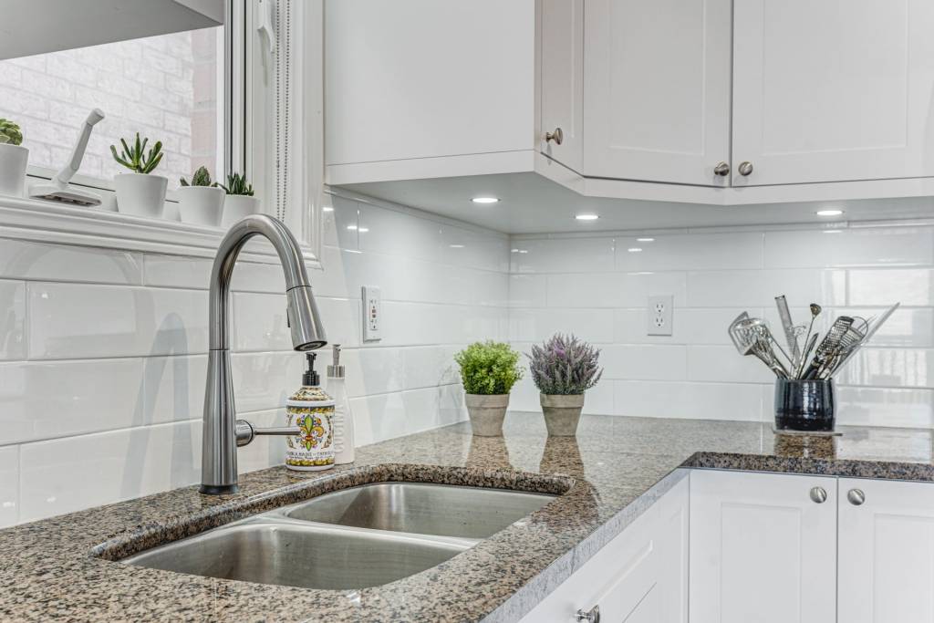 white brick splash wall and double sink in kitchen renovation toronto