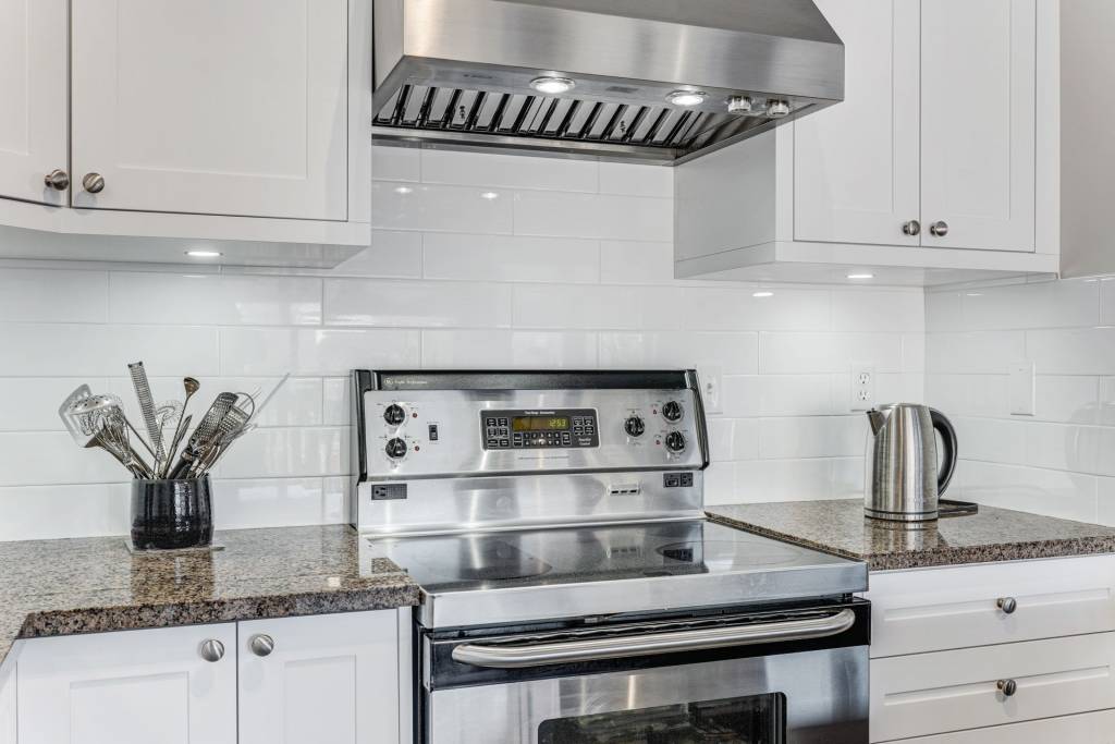 backlit kitchen cabinets and brick white splash wall in custom kitchen renovation