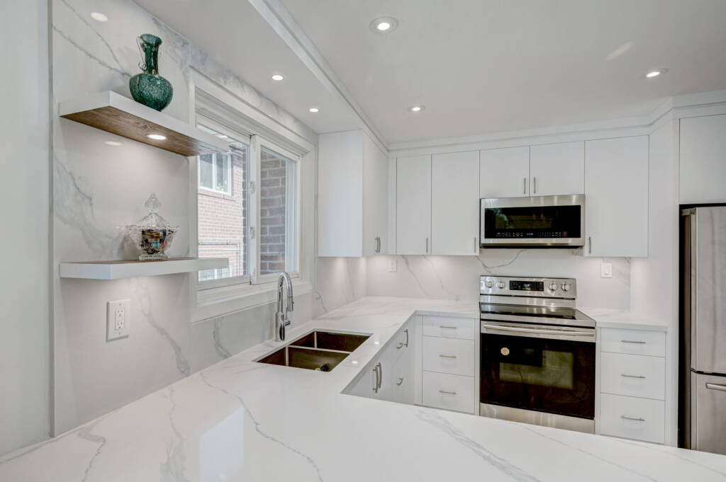 white kitchen cabinets designed by clearview kitchens with white marble backsplash