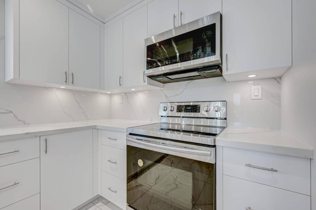 built in appliances with a custom kitchen cabinets - white backsplash 