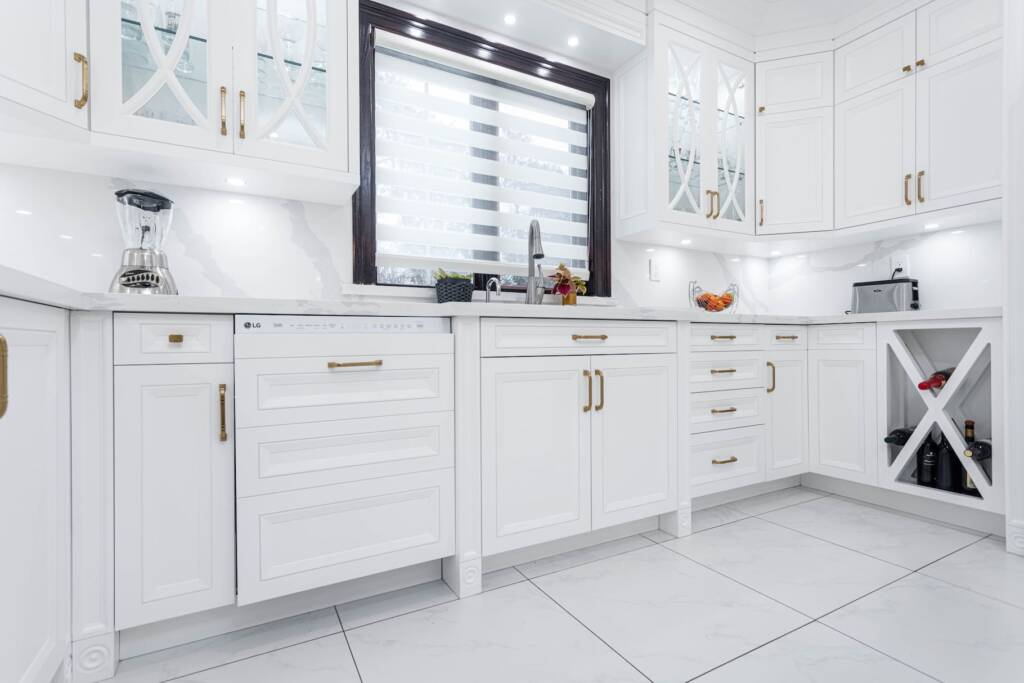 white custom kitchen cabinets with a glass details 