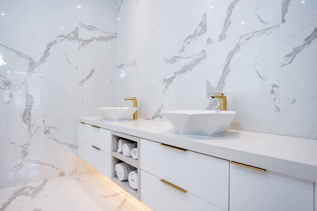 Master Bathroom sinks with marble designed walls and lines
