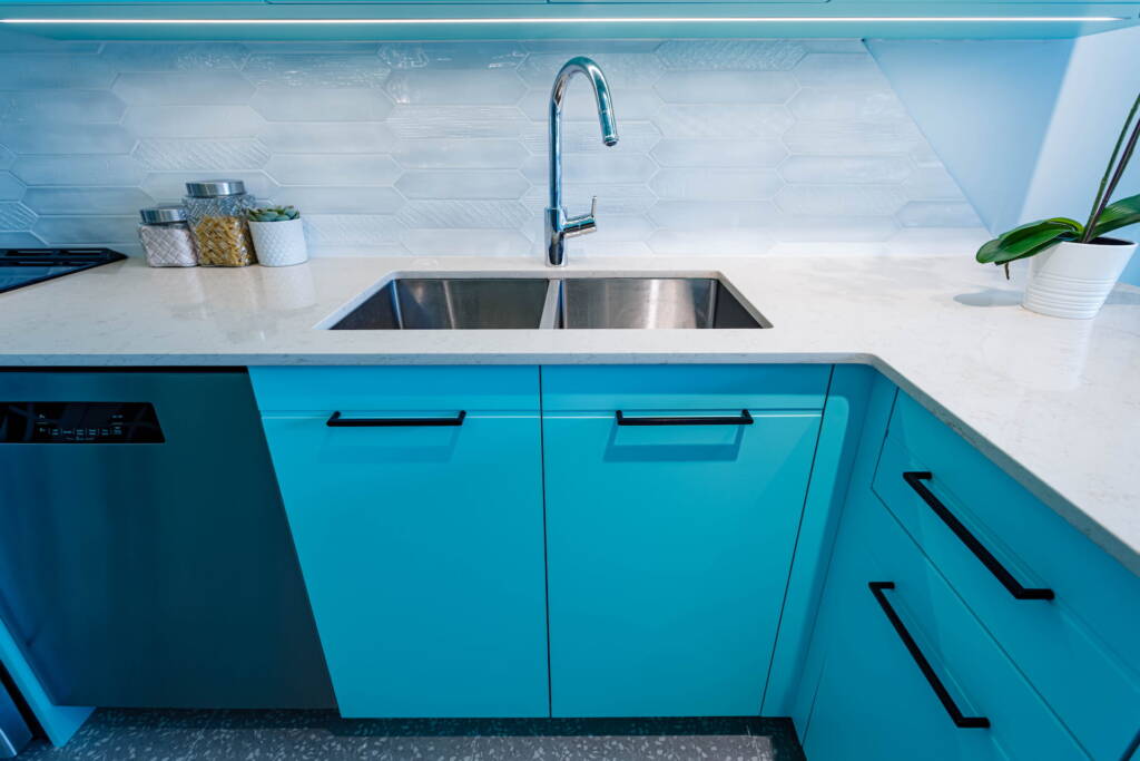 kitchen countertop with a turquoise colored cabinets