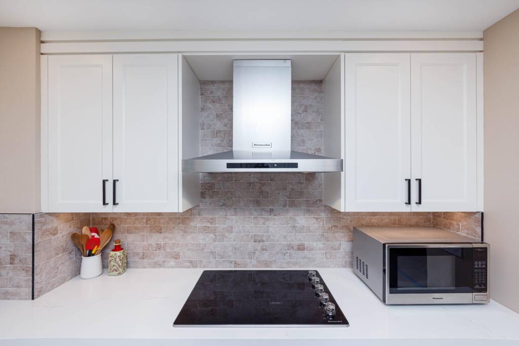 white kitchen cabinets with a build in appliances